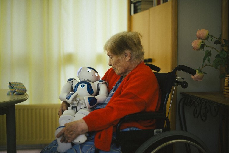Woman in a nursing facility who has developed an emotional attachment to a robot
