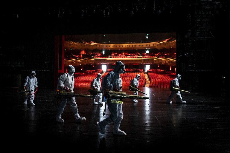 Volunteers dressed in hazmat suits disinfect the Qintai Grand Theatre in Wuhan, Hubei province.