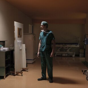 A surgeon looks in on a patient who he earlier gave a liver transplant