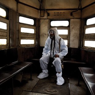 A tram conductor in Kolkata, India, wears protective clothing from head to toe during the Covid-19 pandemic.